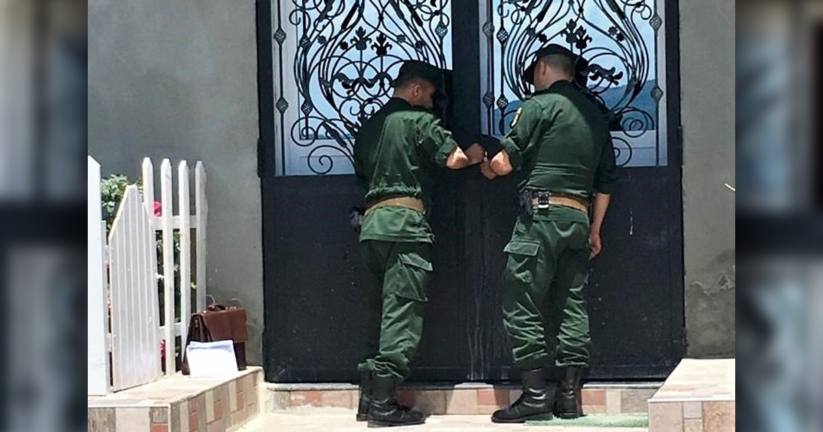 Officials sealing a church door.