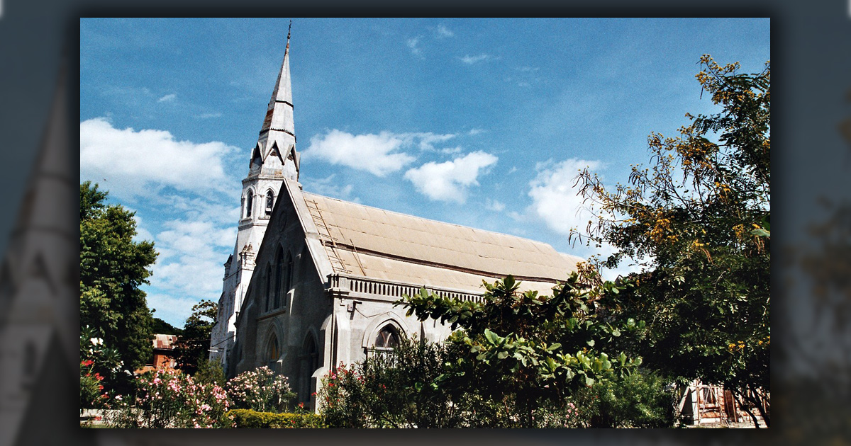 A church surrounded by bushes and trees