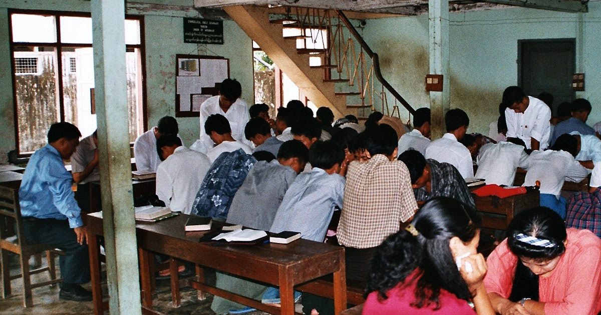 Men and women praying.