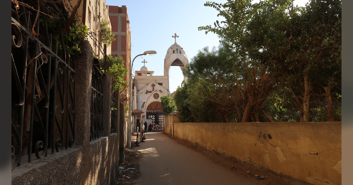 A shaded path leading to a church entry