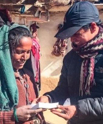 A VOM ministry worker gives this Nepali woman a Bible.