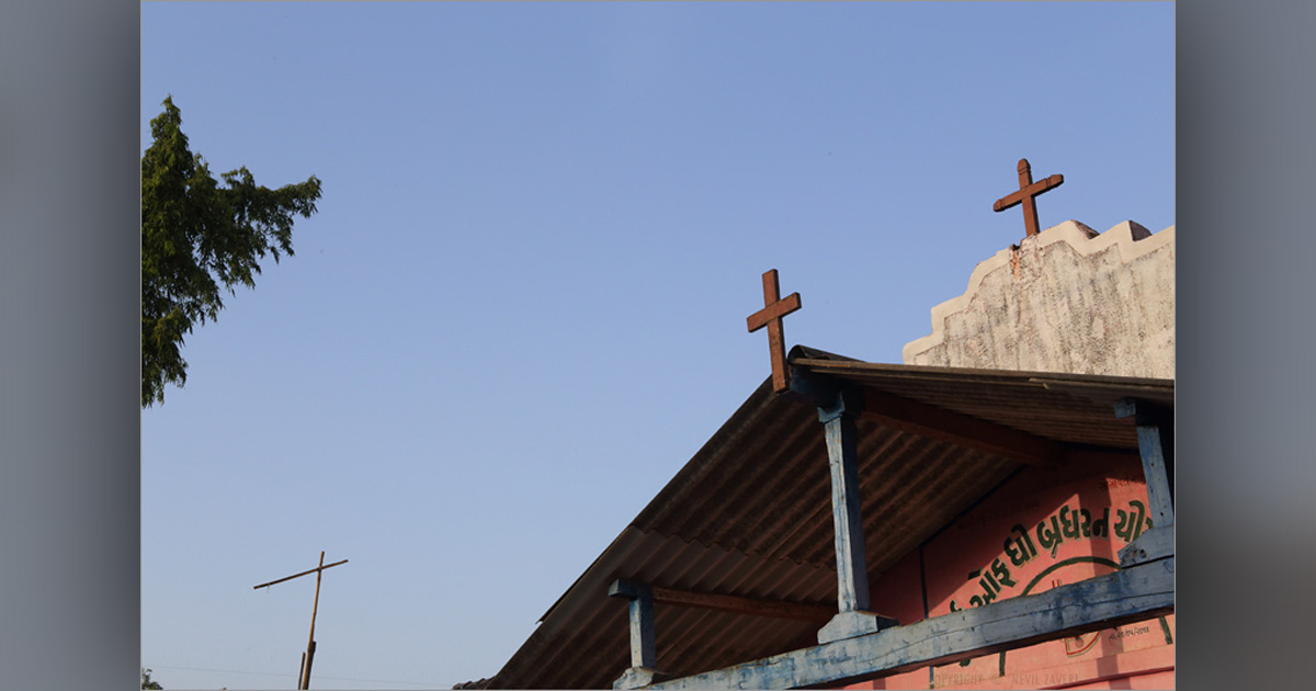 Three crosses from different locations are accented by a blue sky.