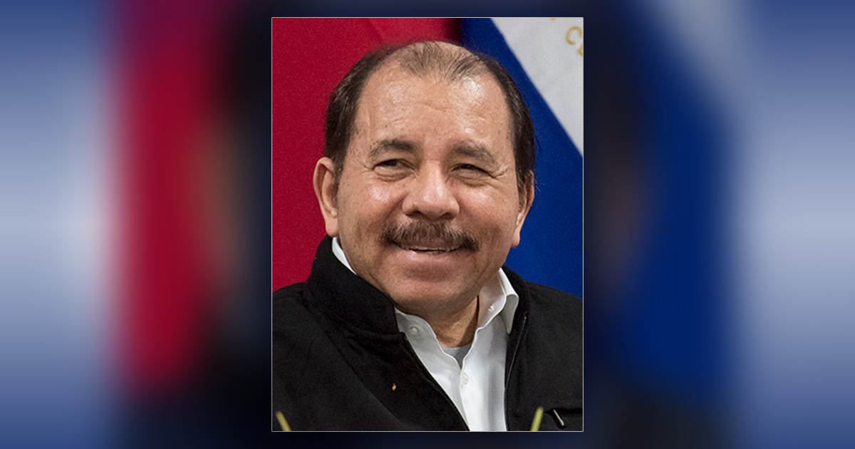 Daniel Ortega is smiling.