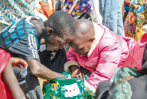 Children opening a Christmas Blessing package