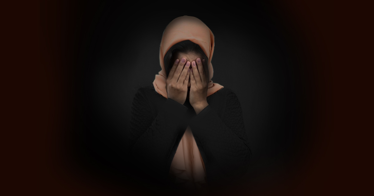 Woman covering her face with her hands