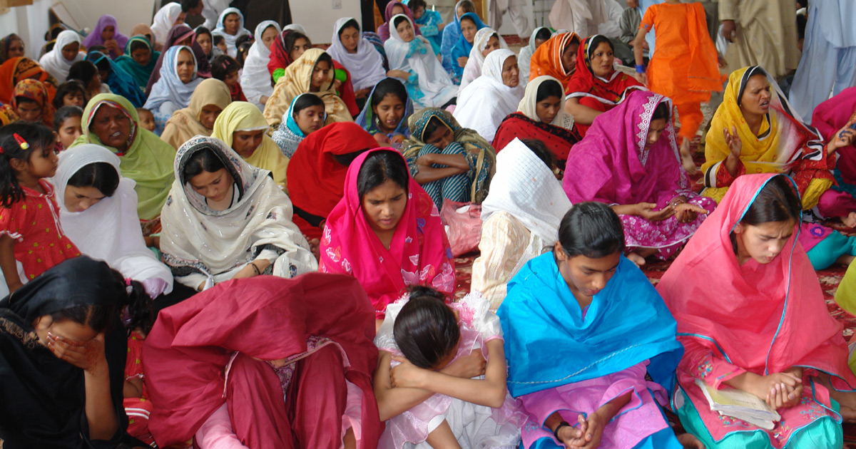 Women kneeling in prayer