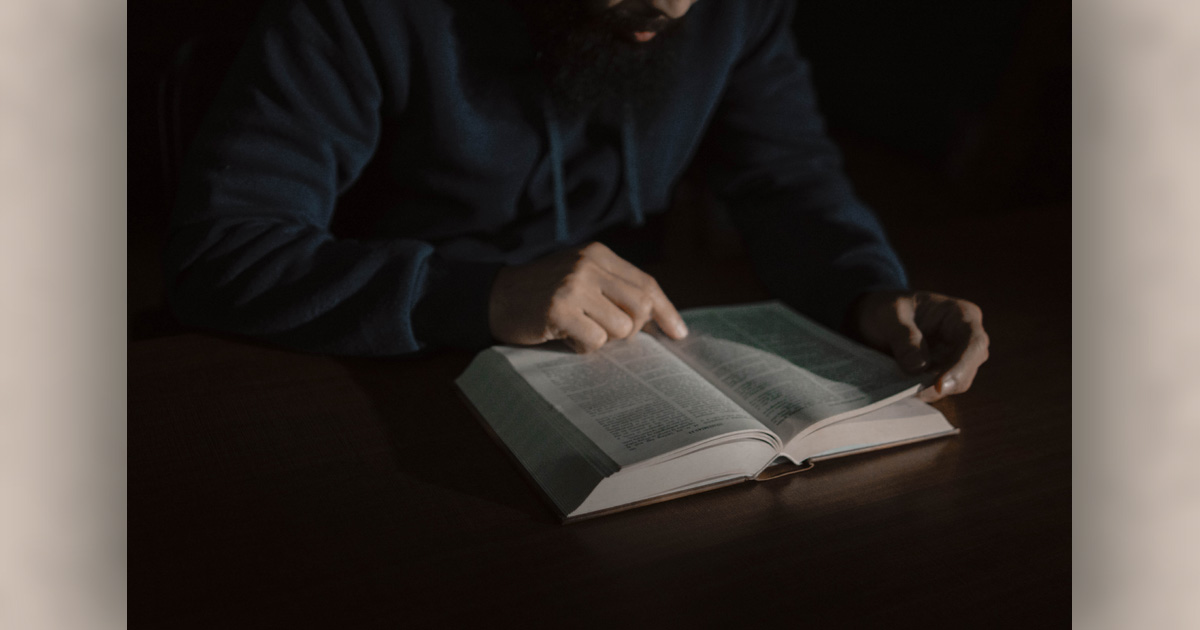 A man reading the Bible (Unsplash image)