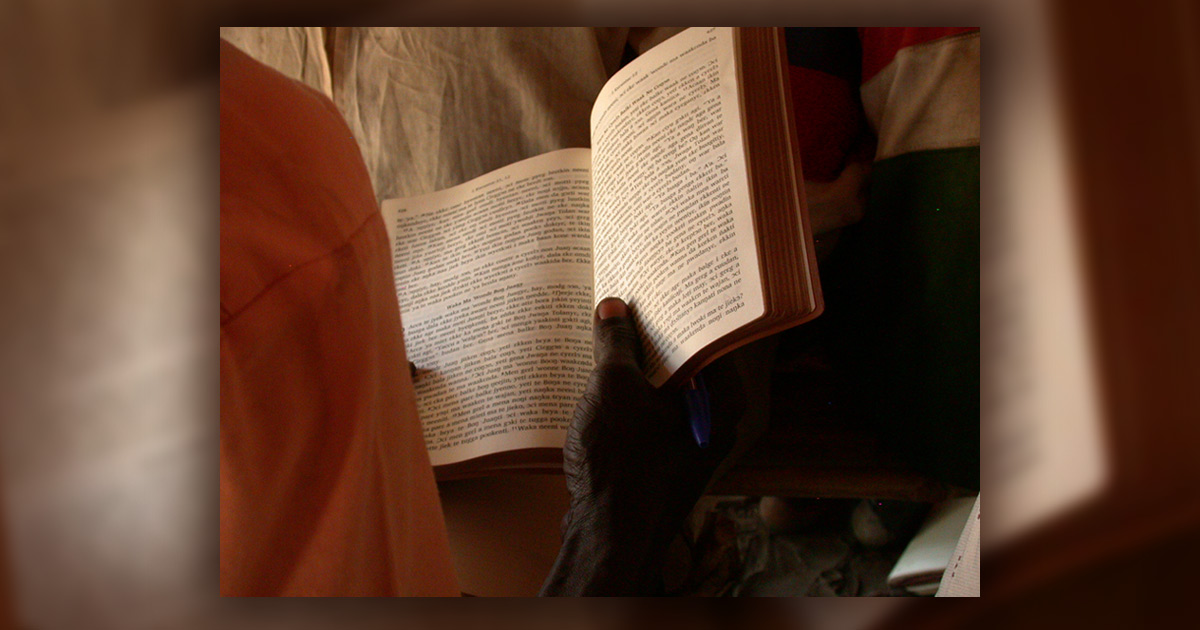 Sudanese man reading the Bible