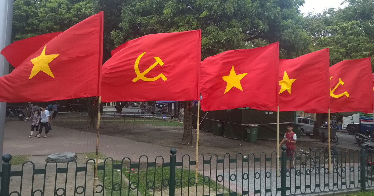 Flags of the Communist Party of Vietnam and the nation of Vietnam are flying together.