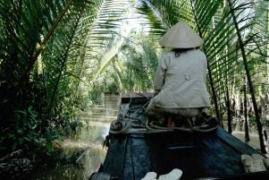 A woman in Vietnam riding in a boat