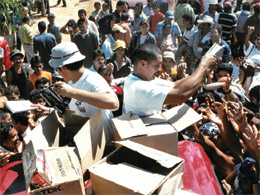 A large crowd awaits the distribution of Christian literature.