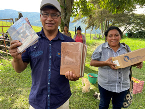 A man and woman holding boxes of resources.