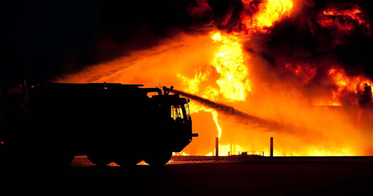 A water truck is working to douse a fire.