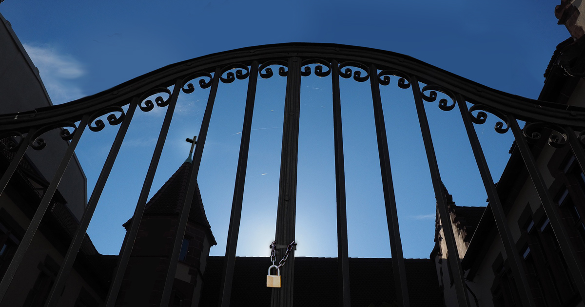 Locked gate with a church behind