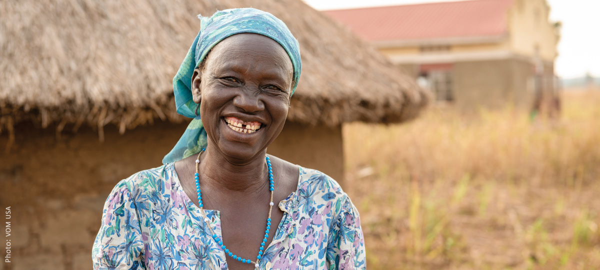 A woman has a wide, beautiful smile.